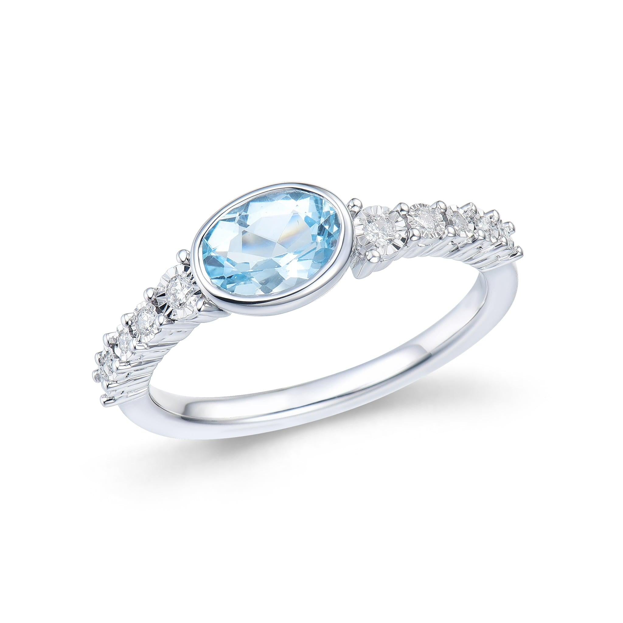 9ct White Gold Oval Blue Topaz Ring With Illision Set Diamond Shoulders.