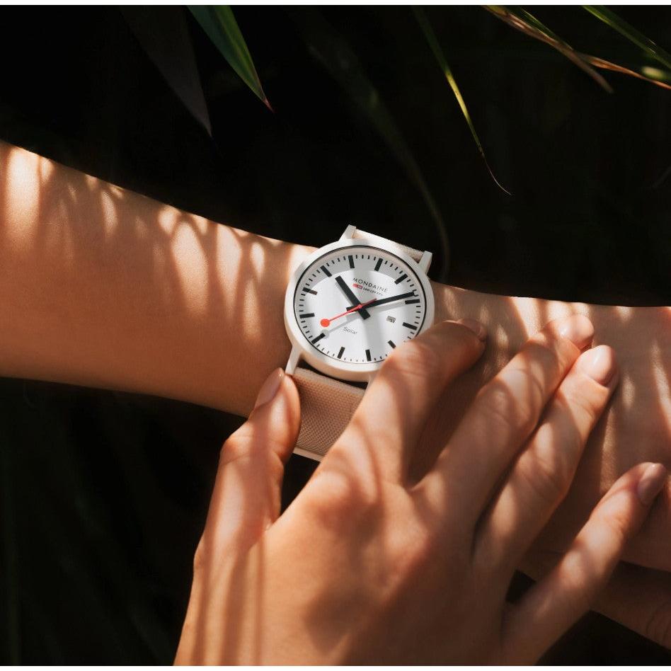 Mondaine Essence Solar Watch. White Dial, Off White Textile Strap.
